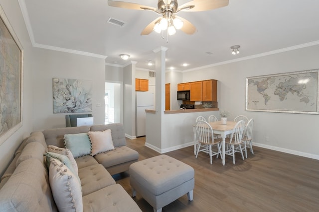 living room with hardwood / wood-style floors, ceiling fan, and crown molding