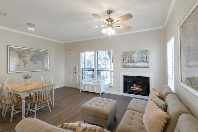 living room featuring crown molding, ceiling fan, and dark wood-type flooring