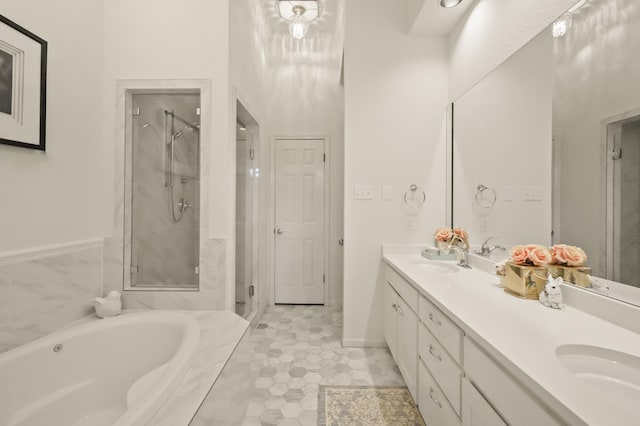 full bath featuring a sink, a garden tub, a stall shower, and double vanity