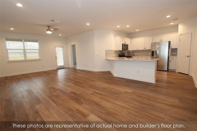 kitchen featuring white cabinetry, ceiling fan, stainless steel appliances, and hardwood / wood-style flooring