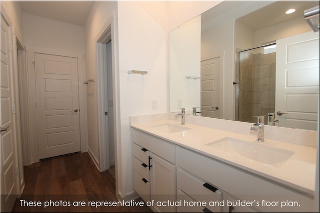 bathroom with vanity, hardwood / wood-style flooring, and a shower with shower door