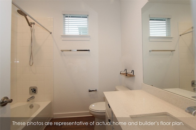 full bathroom featuring vanity, a healthy amount of sunlight, toilet, and wood-type flooring