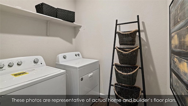 clothes washing area with washing machine and dryer