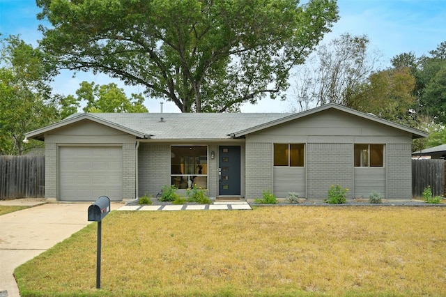 ranch-style house featuring a front lawn and a garage