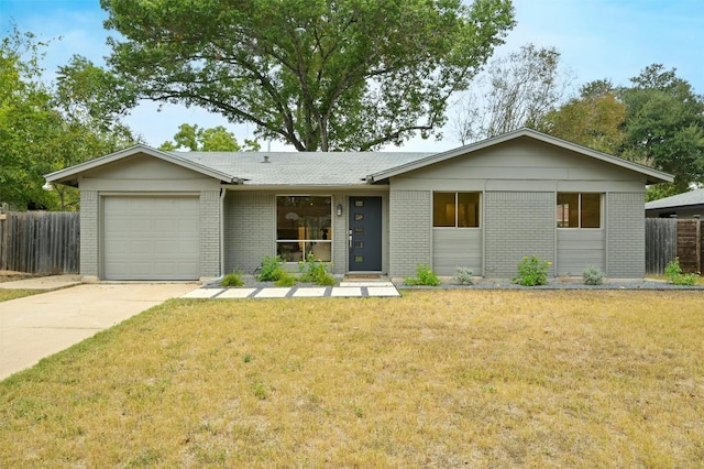 ranch-style house with a garage and a front lawn