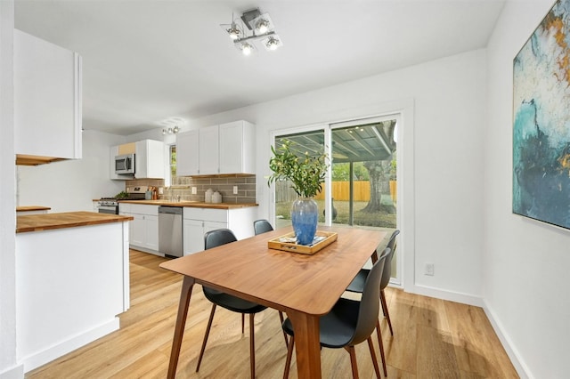 dining space with light hardwood / wood-style floors