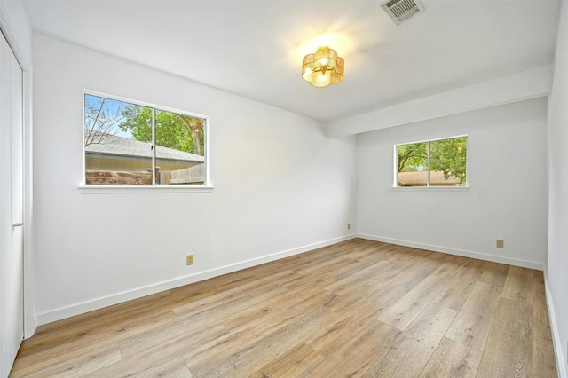 spare room with plenty of natural light and light wood-type flooring