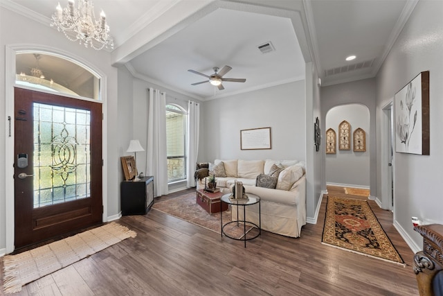 entrance foyer with dark hardwood / wood-style flooring, crown molding, and a wealth of natural light