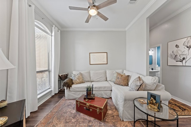 living room featuring dark hardwood / wood-style floors, crown molding, and a healthy amount of sunlight