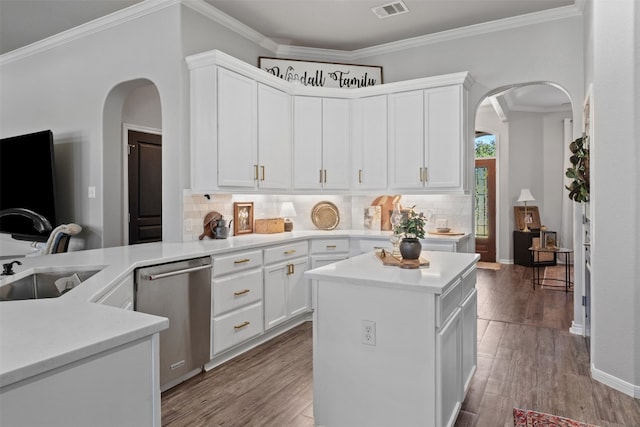 kitchen featuring dishwasher, sink, a kitchen island, light hardwood / wood-style flooring, and white cabinets