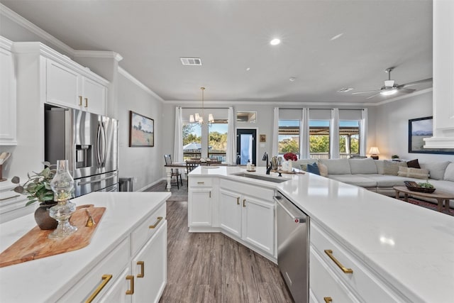 kitchen featuring sink, crown molding, light hardwood / wood-style flooring, appliances with stainless steel finishes, and white cabinetry