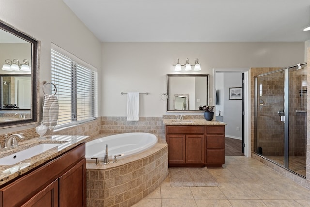 bathroom with tile patterned flooring, vanity, and plus walk in shower