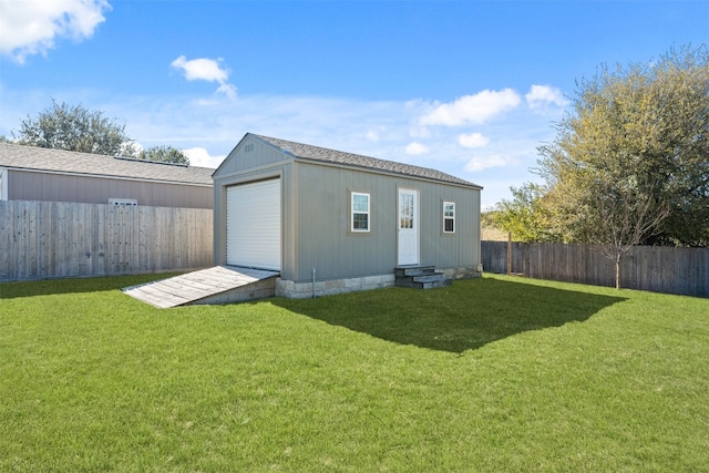 back of house featuring an outdoor structure and a lawn