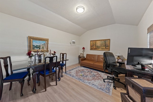 home office featuring light hardwood / wood-style flooring and vaulted ceiling