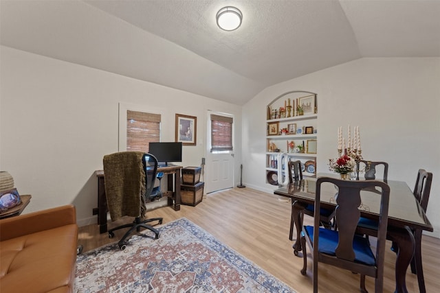 office featuring light hardwood / wood-style floors and lofted ceiling