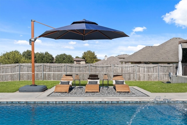 view of pool featuring a lawn and a patio area