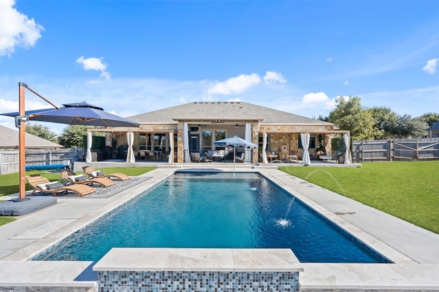 view of pool featuring a patio, pool water feature, ceiling fan, and a lawn