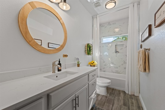 full bathroom featuring toilet, hardwood / wood-style floors, vanity, and shower / tub combo with curtain