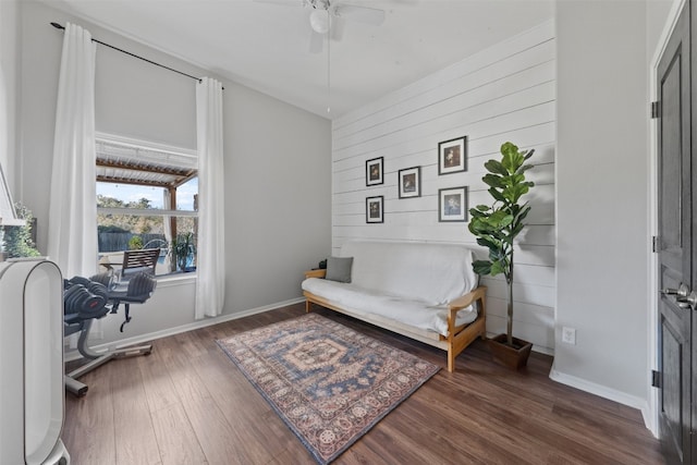 living area featuring dark hardwood / wood-style floors and ceiling fan