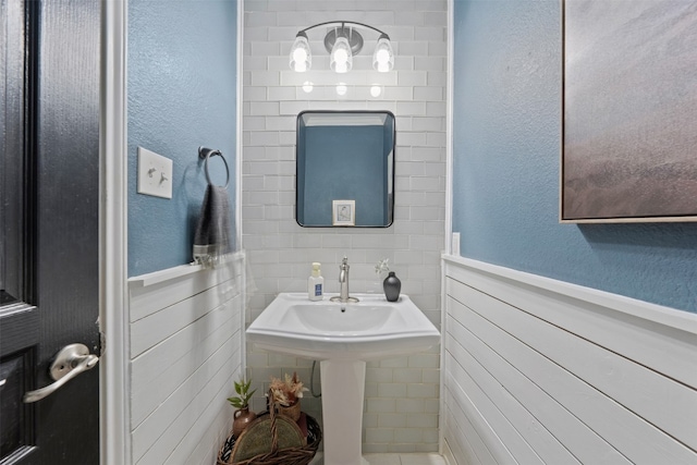 bathroom with tile walls