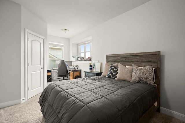 carpeted bedroom featuring baseboards