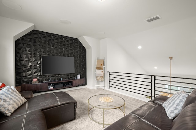 carpeted living room featuring vaulted ceiling