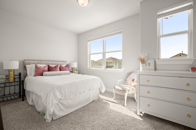 carpeted bedroom featuring baseboards