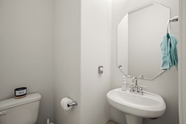 half bathroom with a sink and toilet