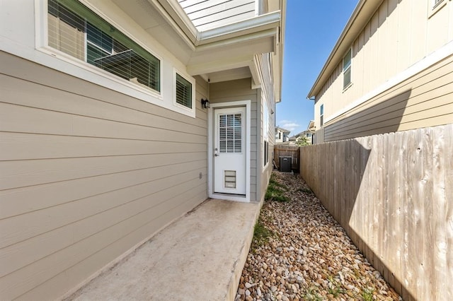 doorway to property featuring fence