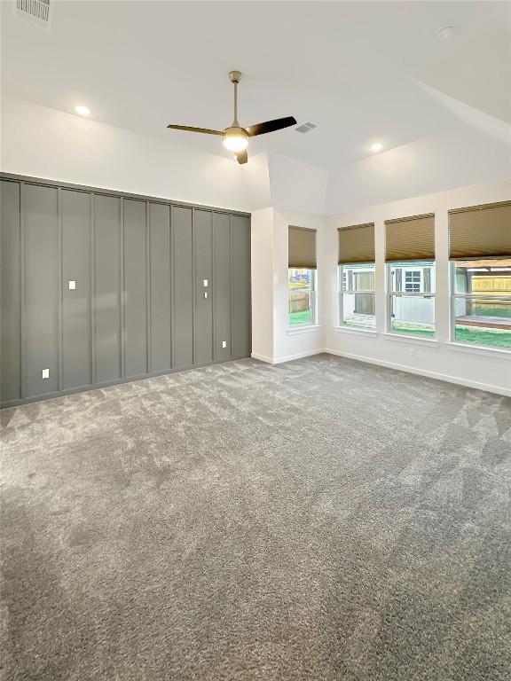 interior space featuring ceiling fan, visible vents, and baseboards