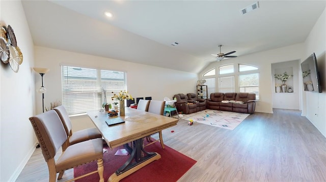 dining space featuring ceiling fan, light wood-type flooring, and lofted ceiling