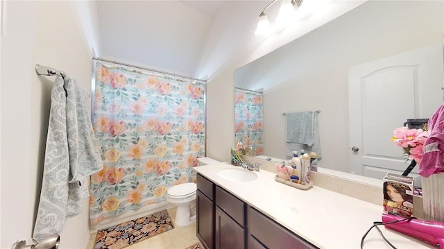 bathroom with tile patterned flooring, vanity, and toilet