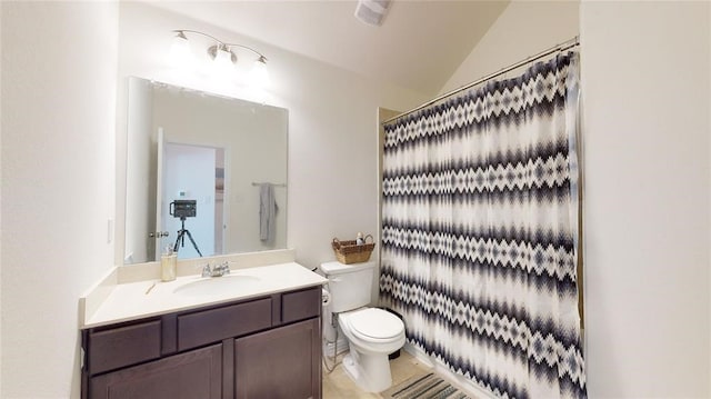 bathroom featuring toilet, vaulted ceiling, tile patterned flooring, curtained shower, and vanity