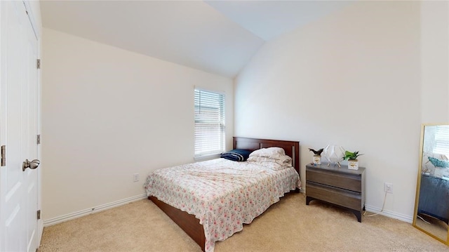 carpeted bedroom featuring vaulted ceiling