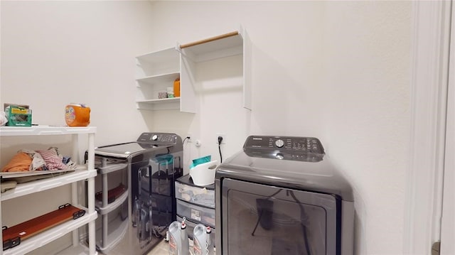 clothes washing area featuring independent washer and dryer