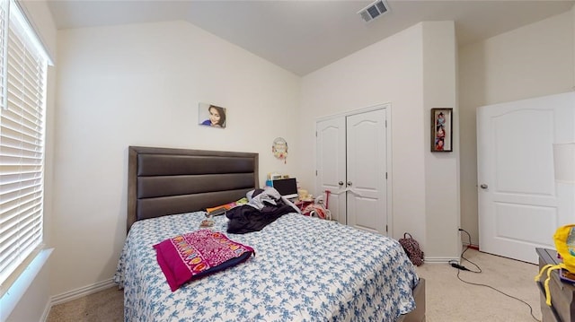 bedroom with lofted ceiling and light carpet