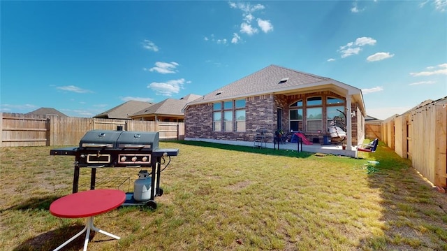 back of property featuring a patio area and a lawn