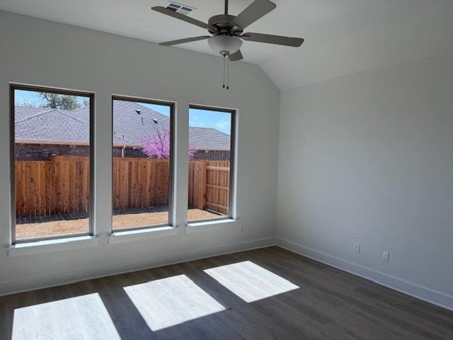 spare room with ceiling fan, baseboards, dark wood-style flooring, and lofted ceiling