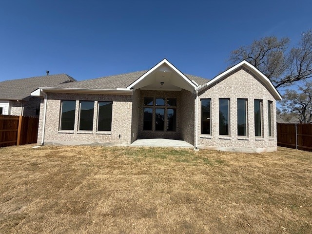 rear view of property with a patio area and brick siding