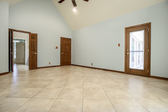 tiled spare room with high vaulted ceiling and ceiling fan