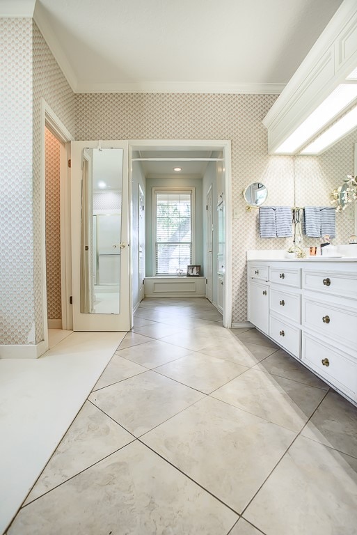 bathroom with crown molding and vanity