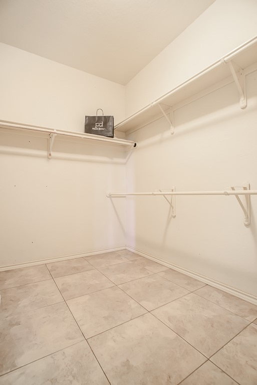 spacious closet featuring tile patterned floors