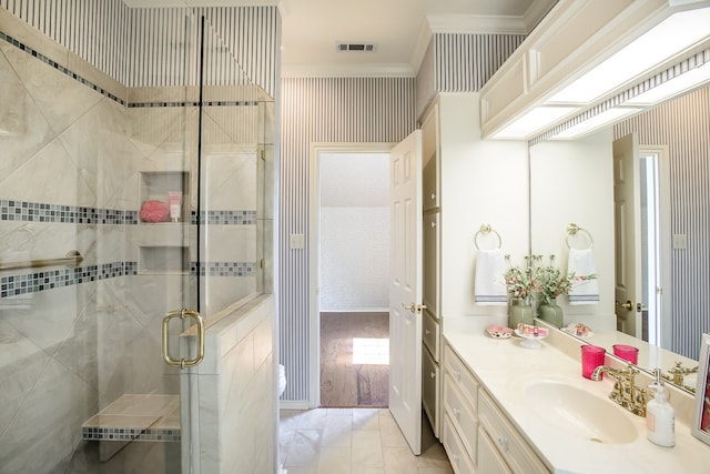 bathroom with hardwood / wood-style floors, vanity, crown molding, and walk in shower