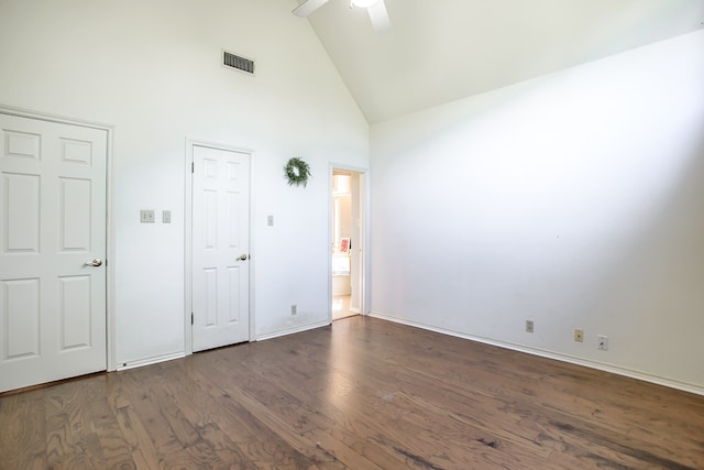 unfurnished bedroom with ceiling fan, dark hardwood / wood-style flooring, high vaulted ceiling, and ensuite bath