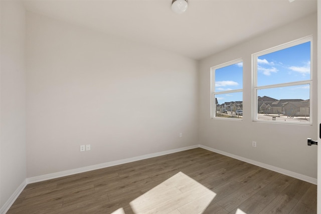 spare room featuring dark hardwood / wood-style flooring