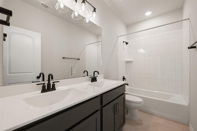 full bathroom with vanity, tile patterned floors, washtub / shower combination, and toilet