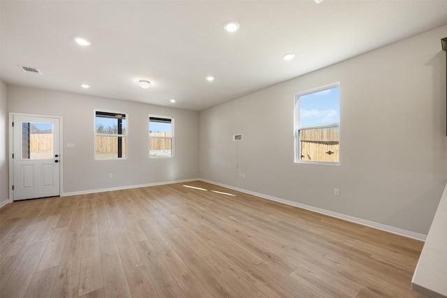 empty room with light hardwood / wood-style floors