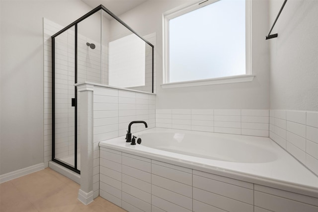 bathroom featuring tile patterned flooring and separate shower and tub