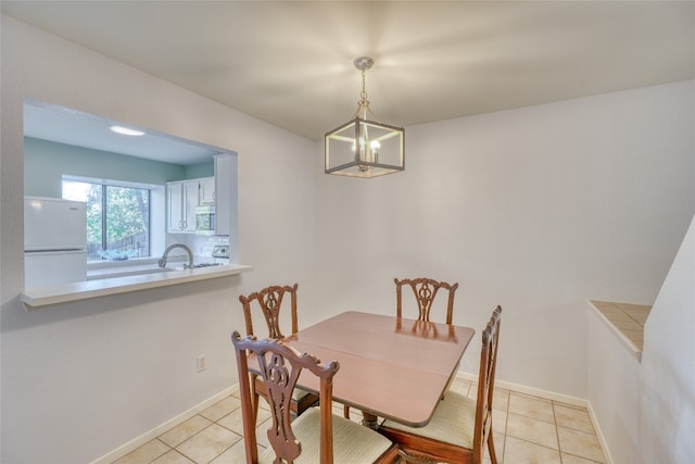 dining space featuring a notable chandelier and light tile patterned flooring