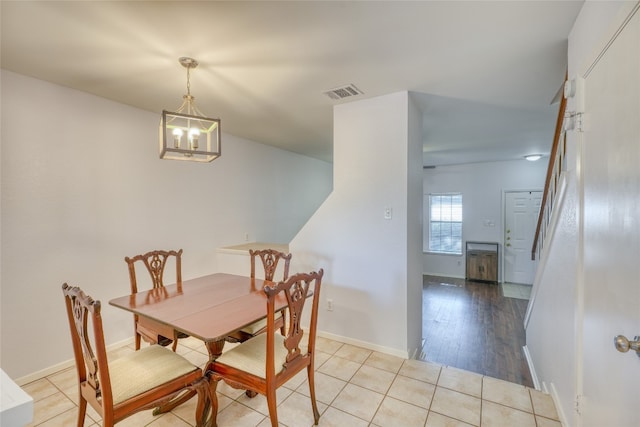 dining space featuring a chandelier and light wood-type flooring